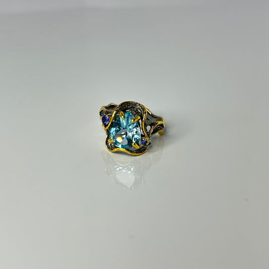 Artisan ring with a blue Topaz centerpiece
