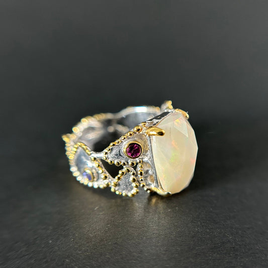 Elegant ring with gemstones on a dark background