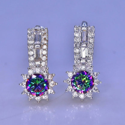 Pair of silver earrings with colorful mystic quartz on a light purple background