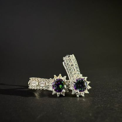 Pair of silver earrings with colorful mystic quartz on a light purple background