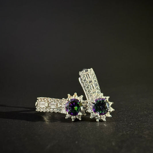 Pair of silver earrings with colorful mystic quartz on a light purple background