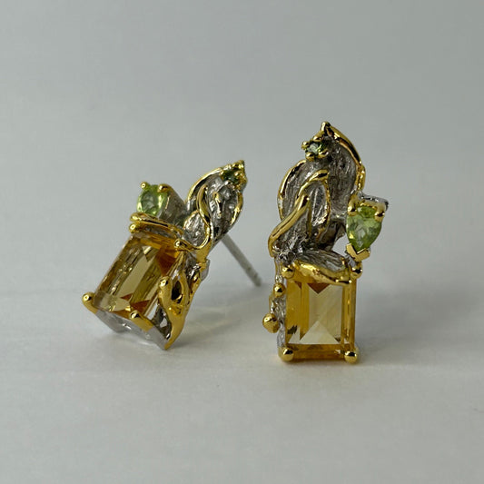 Gold silver earrings with Citrine gemstones on a light gray background