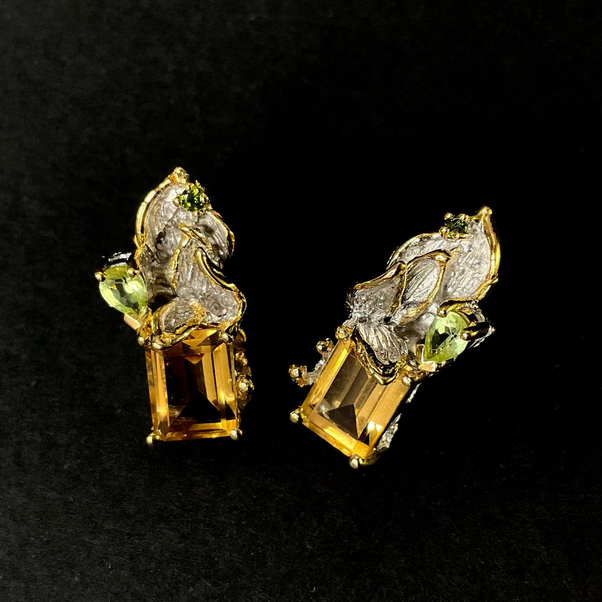 Gold silver earrings with Citrine gemstones on a black background
