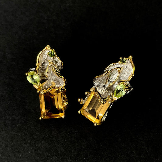 Gold silver earrings with Citrine gemstones on a black background