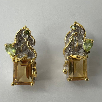 Gold silver earrings with Citrine gemstones on a light gray background