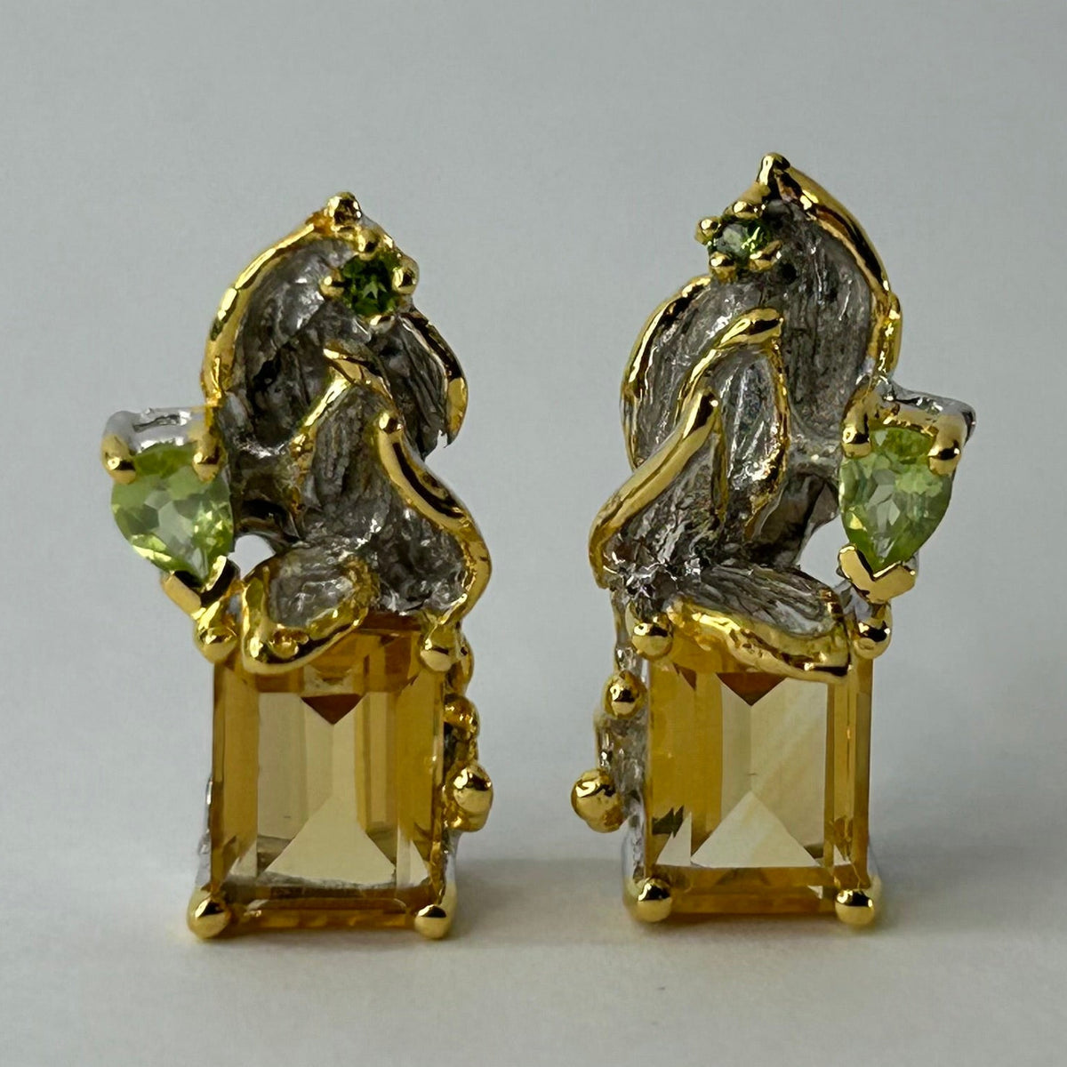 Gold silver earrings with Citrine gemstones on a light gray background