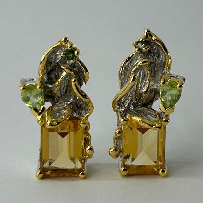 Gold silver earrings with Citrine gemstones on a light gray background