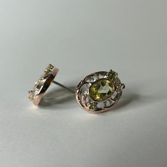 Pair of silver earrings with lemon quartz gemstones on a light gray background
