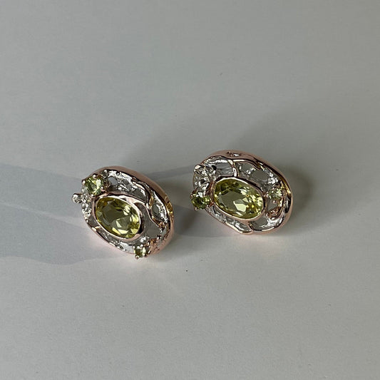 Pair of silver earrings with lemon quartz gemstones on a light gray background