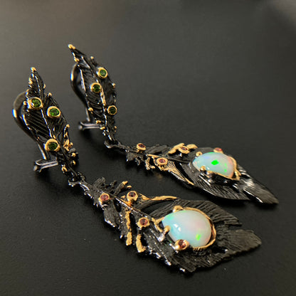 Ornate earrings with opal stones on a dark background
