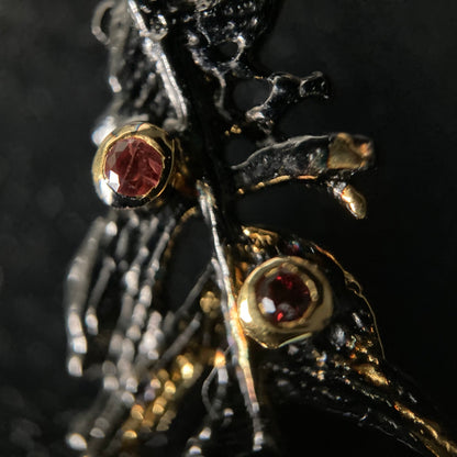 Close-up of a decorative earring with gemstones on a dark background