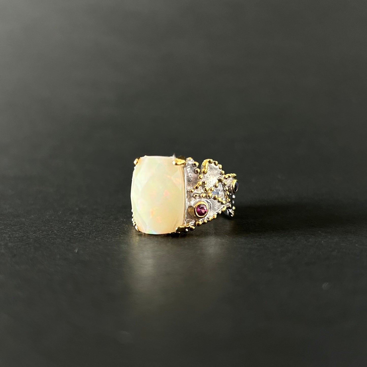 Ethiopian Opal statement ring with Rhodolite and Tanzanite support stones