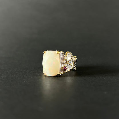 Ethiopian Opal statement ring with Rhodolite and Tanzanite support stones