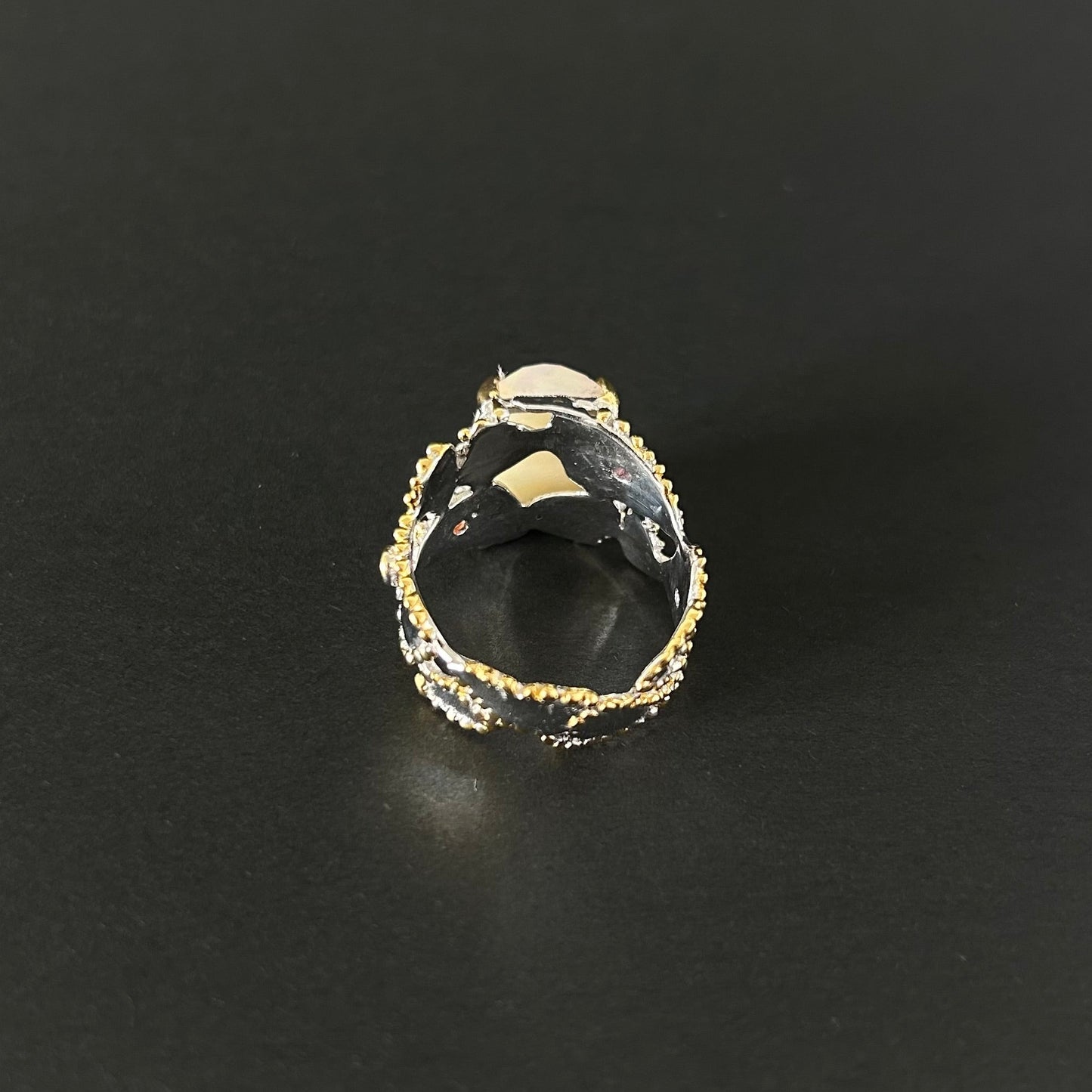 Ethiopian Opal statement ring with Rhodolite and Tanzanite support stones