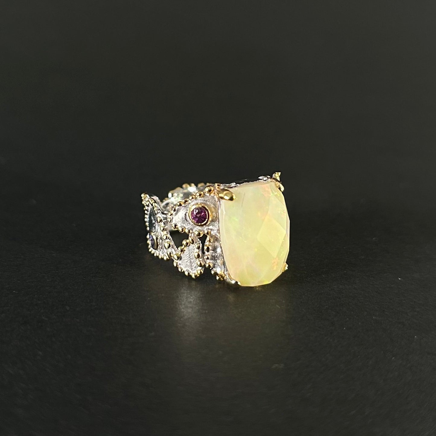 Ethiopian Opal statement ring with Rhodolite and Tanzanite support stones