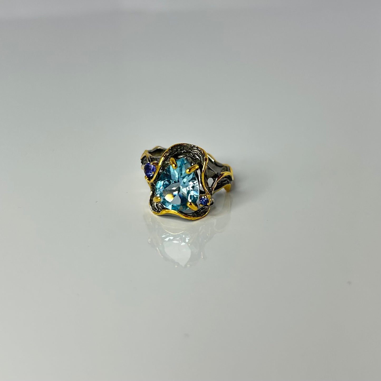 Artisan ring with a blue Topaz centerpiece