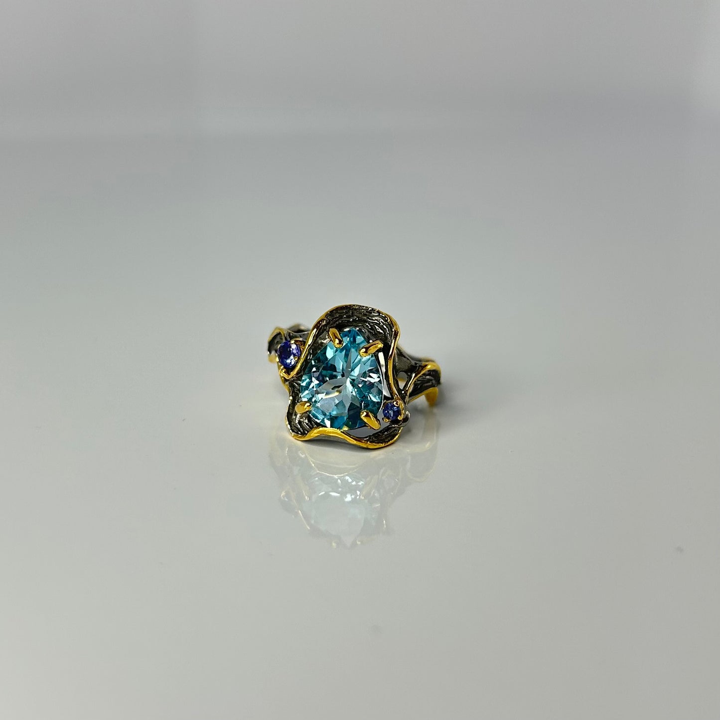 Artisan ring with a blue Topaz centerpiece