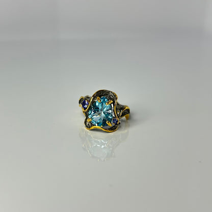 Artisan ring with a blue Topaz centerpiece