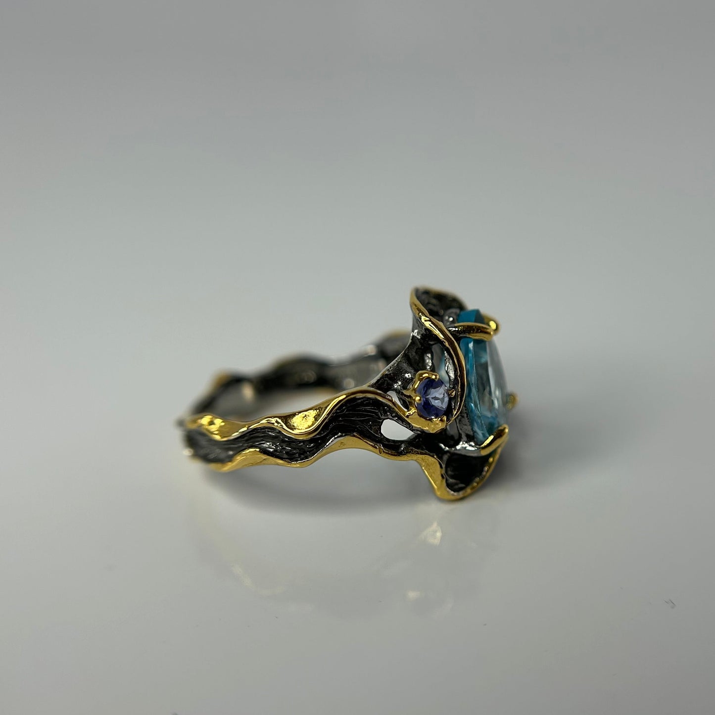 Artisan ring with a blue Topaz centerpiece