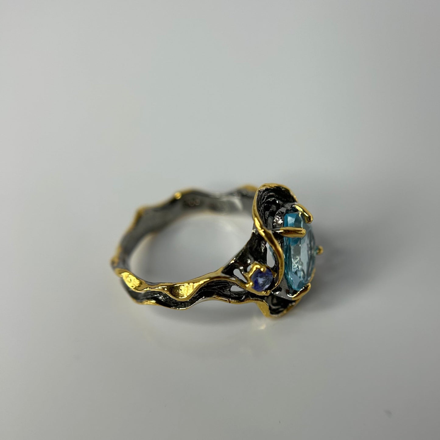 Artisan ring with a blue Topaz centerpiece