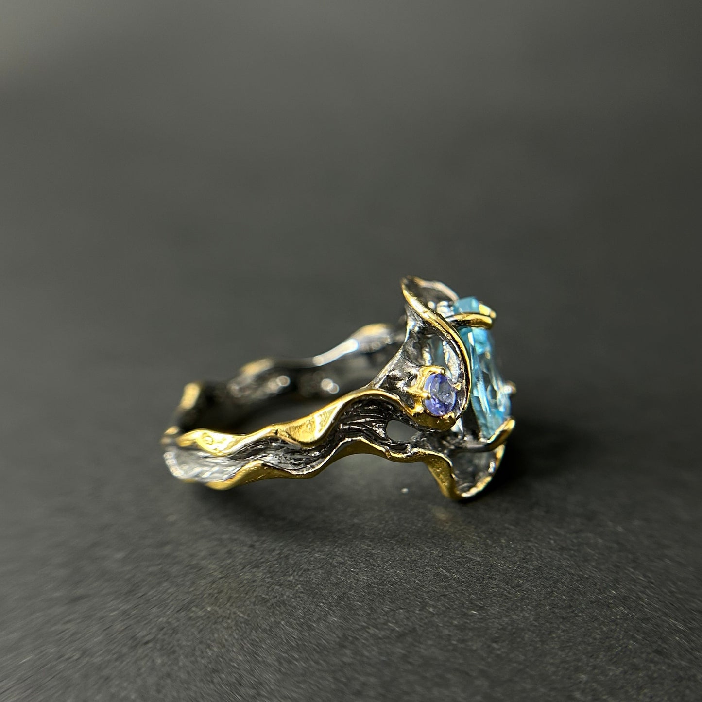 Artisan ring with a blue Topaz centerpiece