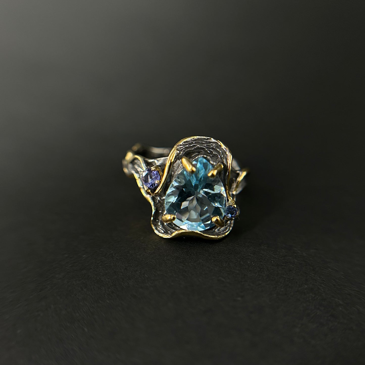 Artisan ring with a blue Topaz centerpiece