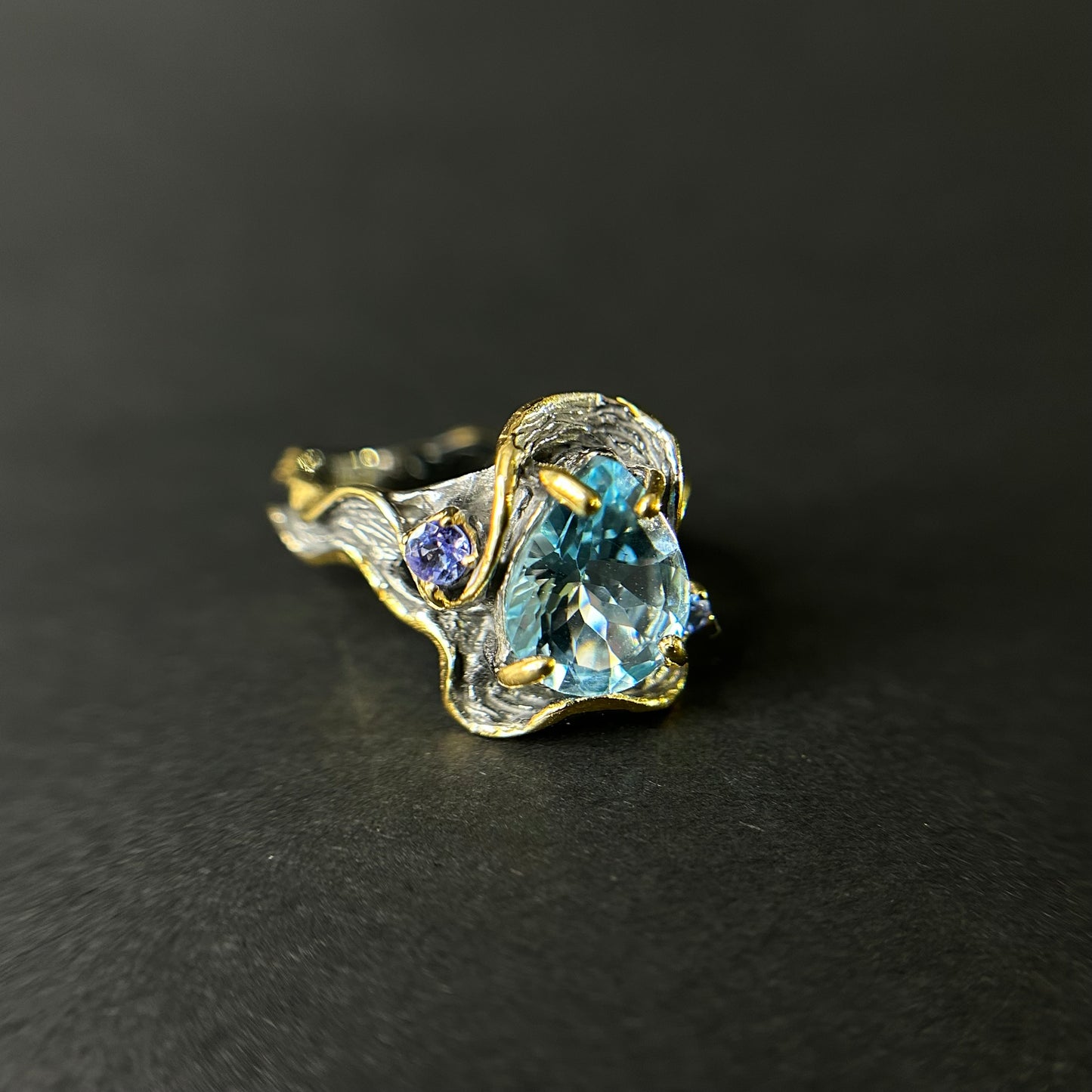 Artisan ring with a blue Topaz centerpiece