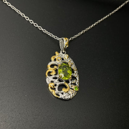 Decorative pendant with green gemstone on a chain against a dark background