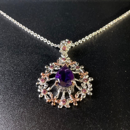 Jewelry pendant with purple gemstone on a black background