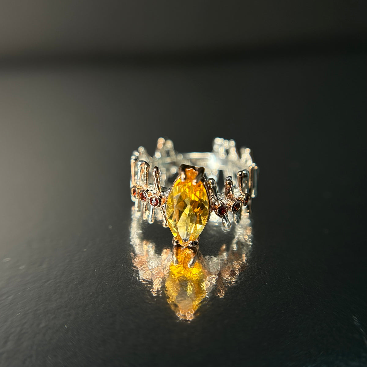 Silver ring with a yellow Citrine gemstone on a dark background