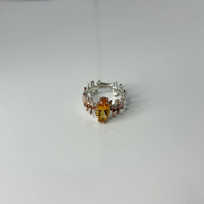 Silver ring with a yellow Citrine gemstone on a white background