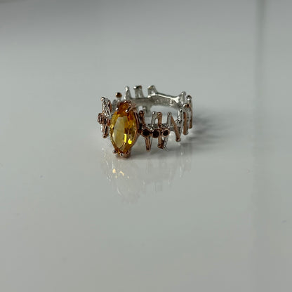Silver ring with a yellow Citrine gemstone on a white background