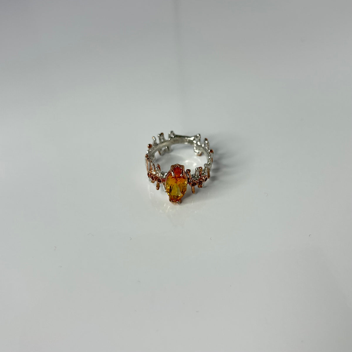 Silver ring with a yellow Citrine gemstone on a white background