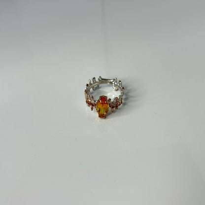 Silver ring with a yellow Citrine gemstone on a white background