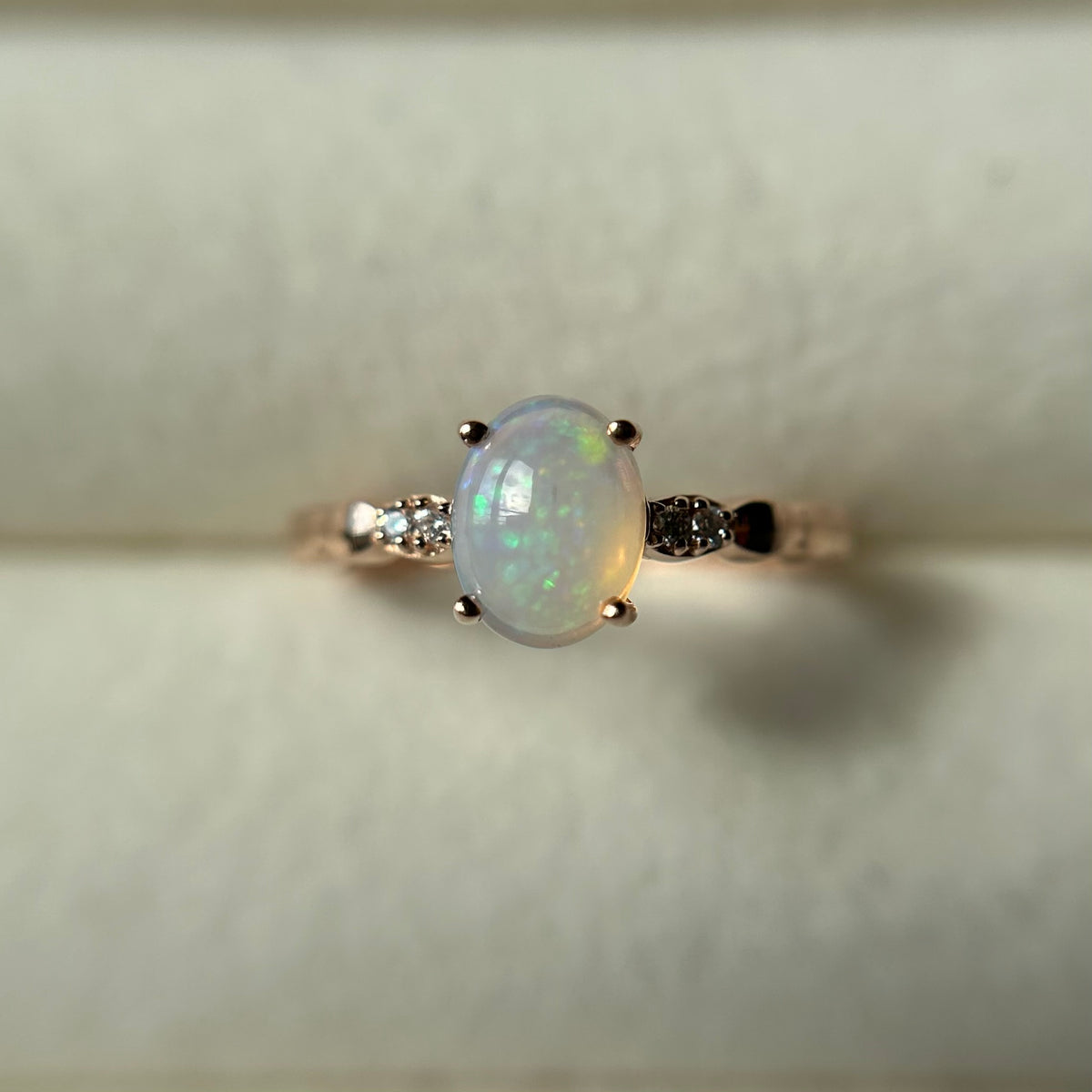 Silver ring with an opal stone on a light background