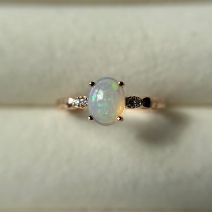 Silver ring with an opal stone on a light background