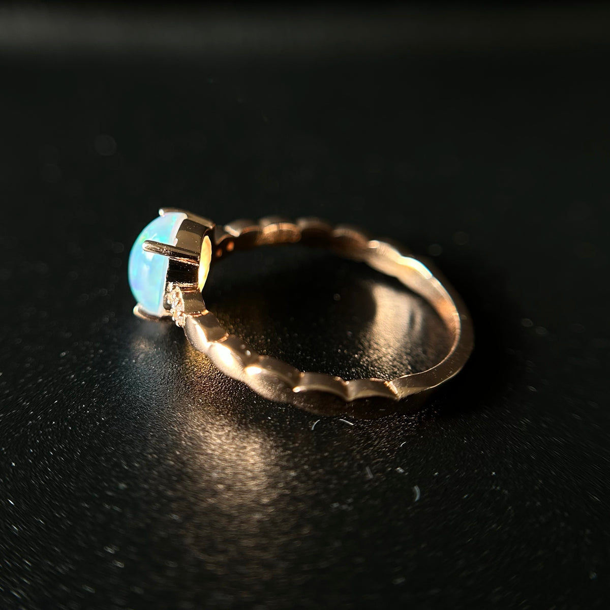 Silver ring with an opal stone on a black background