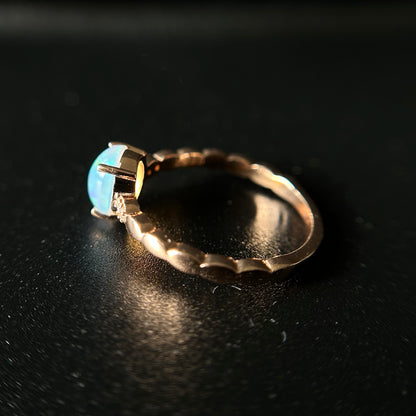 Silver ring with an opal stone on a black background
