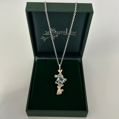 Silver necklace with pendant in a 'Silverleaf' box on a white background