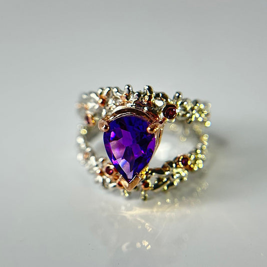 Silver Ring with a purple Amethyst gemstone on a light gray background