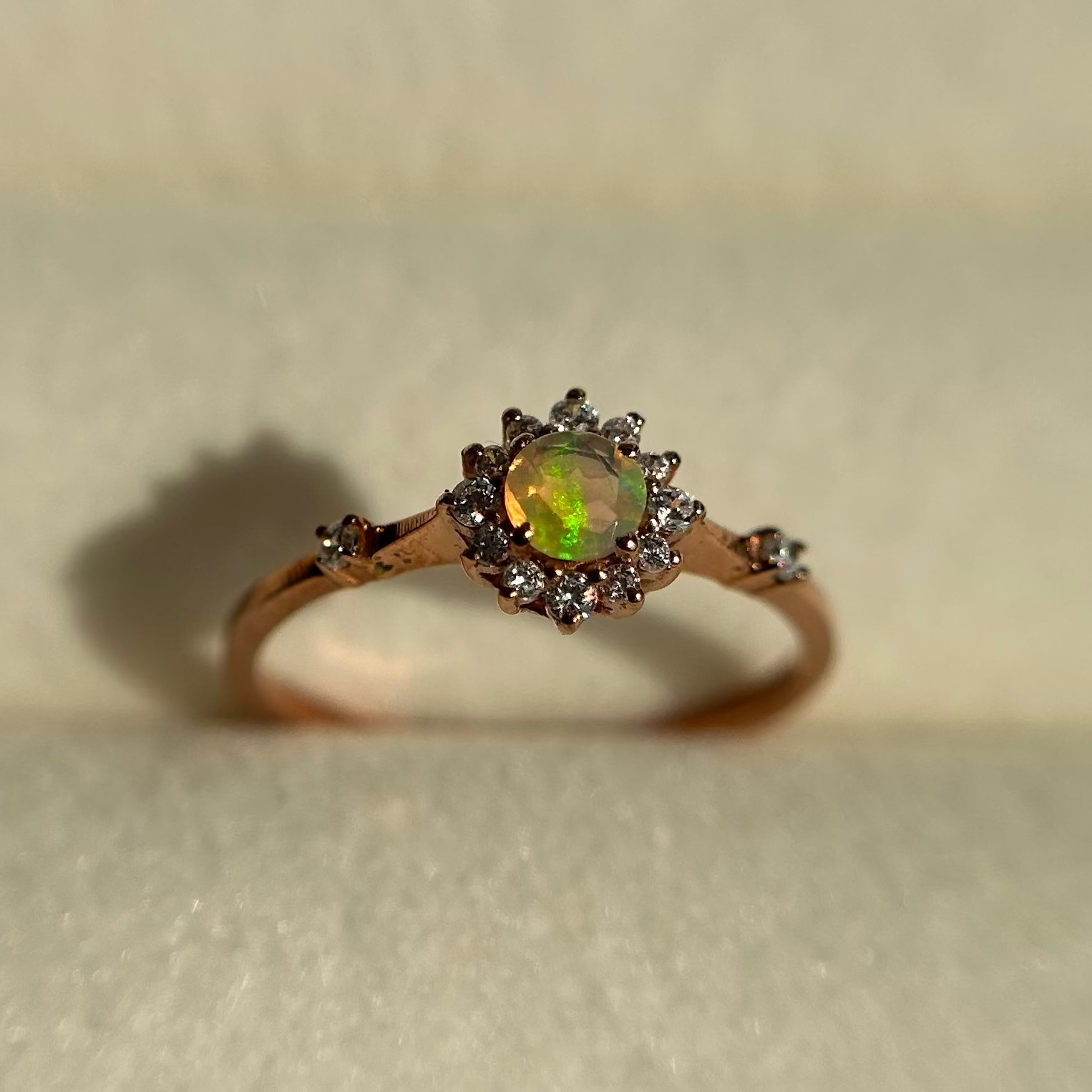 Silver ring with an opal stone on a neutral background