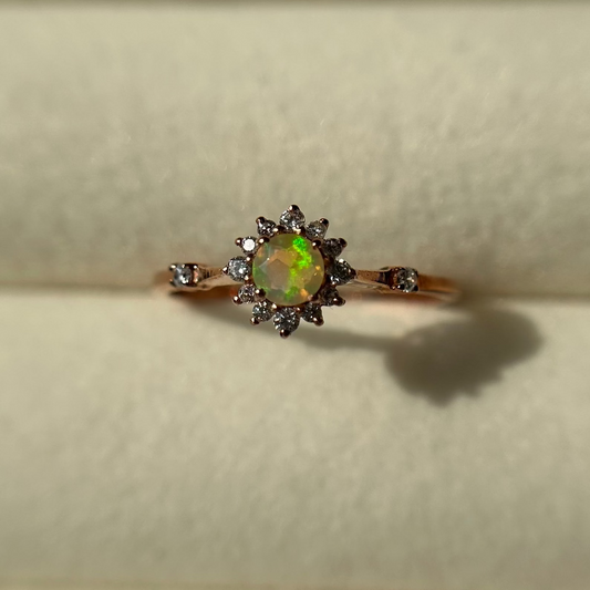 Silver ring with an opal stone on a neutral background