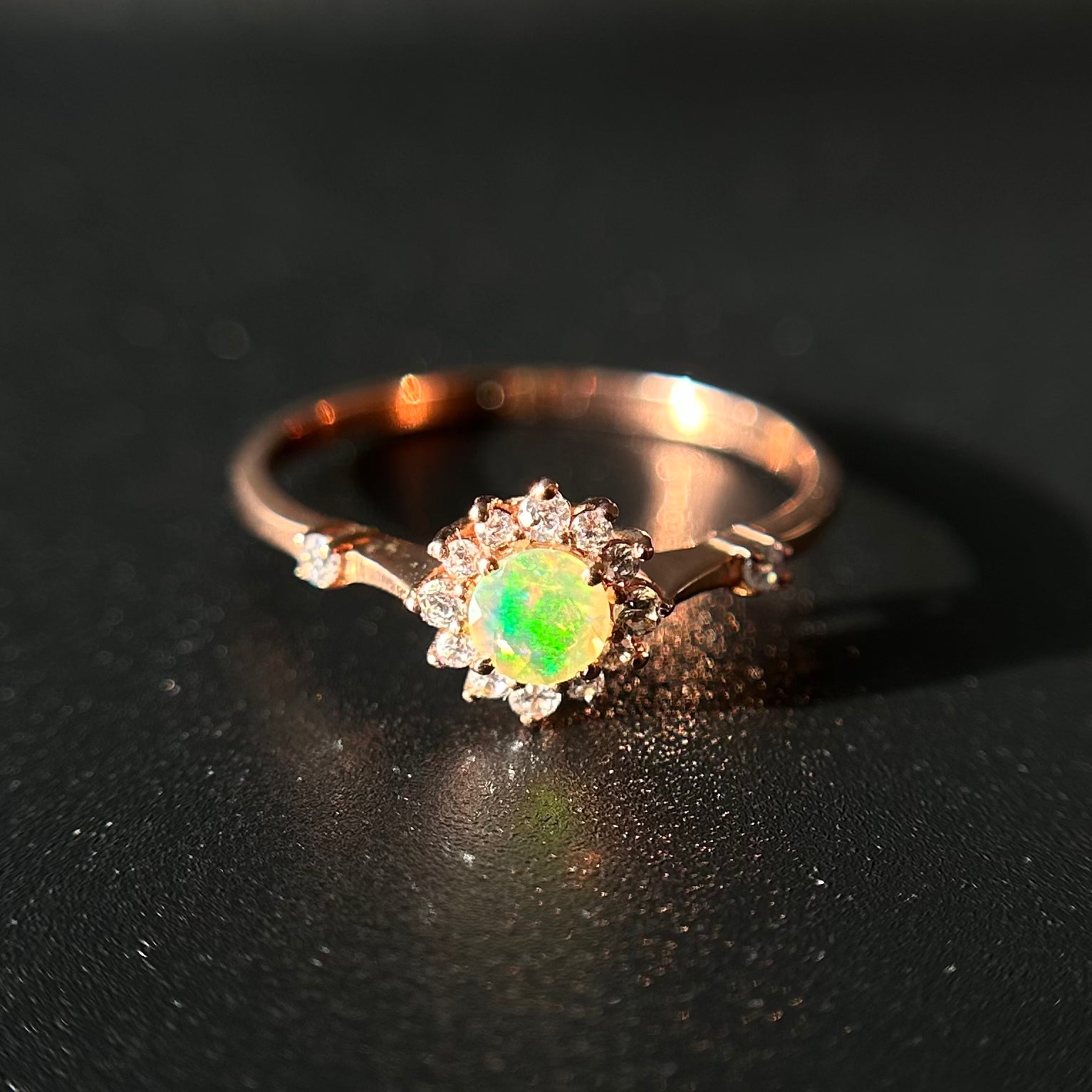 Silver ring with an opal stone on a black background