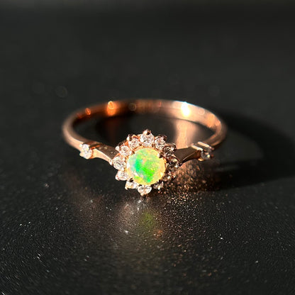 Silver ring with an opal stone on a black background