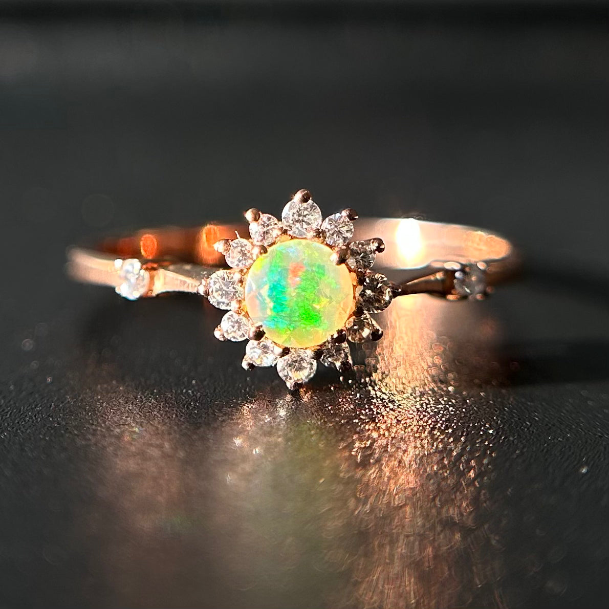 Silver ring with an opal stone on a black background