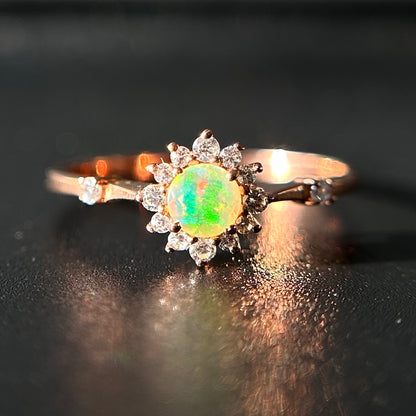 Silver ring with an opal stone on a black background