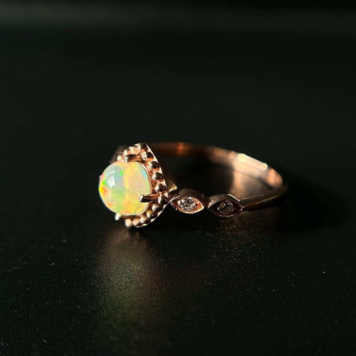 Silver ring with a opal stone on a black background