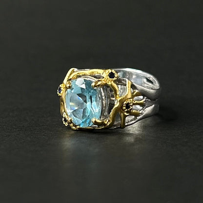 Ring with a blue gemstone on a black background