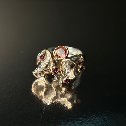 Silver ring with gemstones on a black background