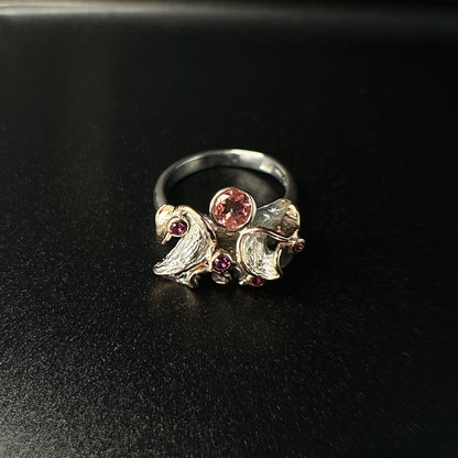 Silver ring with gemstones on a black background
